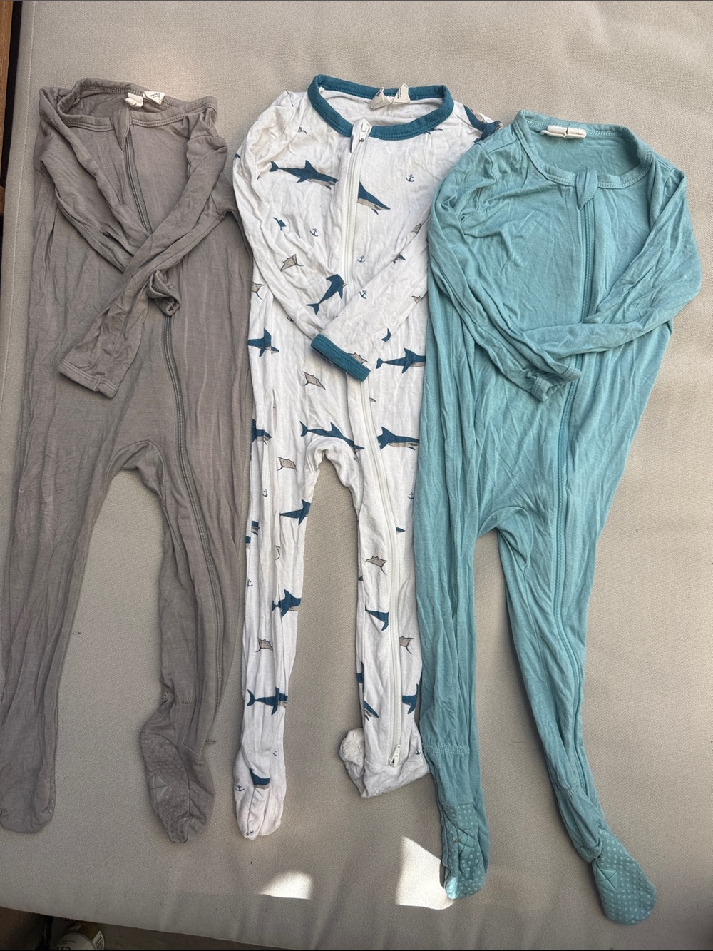 Kyte BABY Three-Pack Zip Footed Pajamas — Gray, White with Blue Sharks, Teal